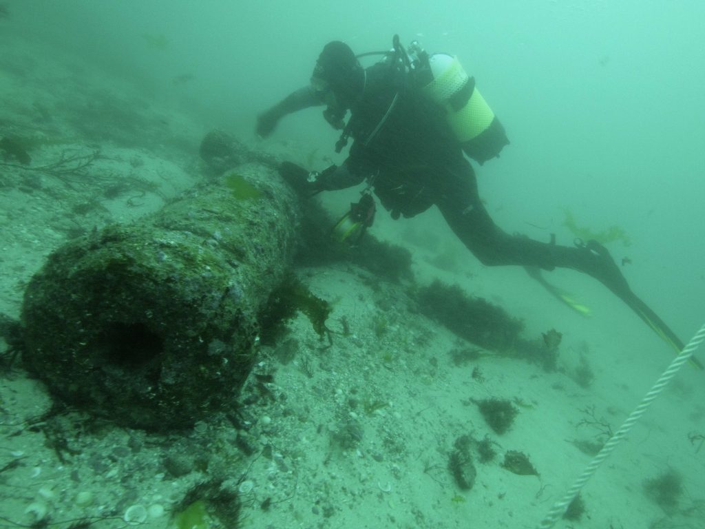 An archaeologist diver surveying Gun 10